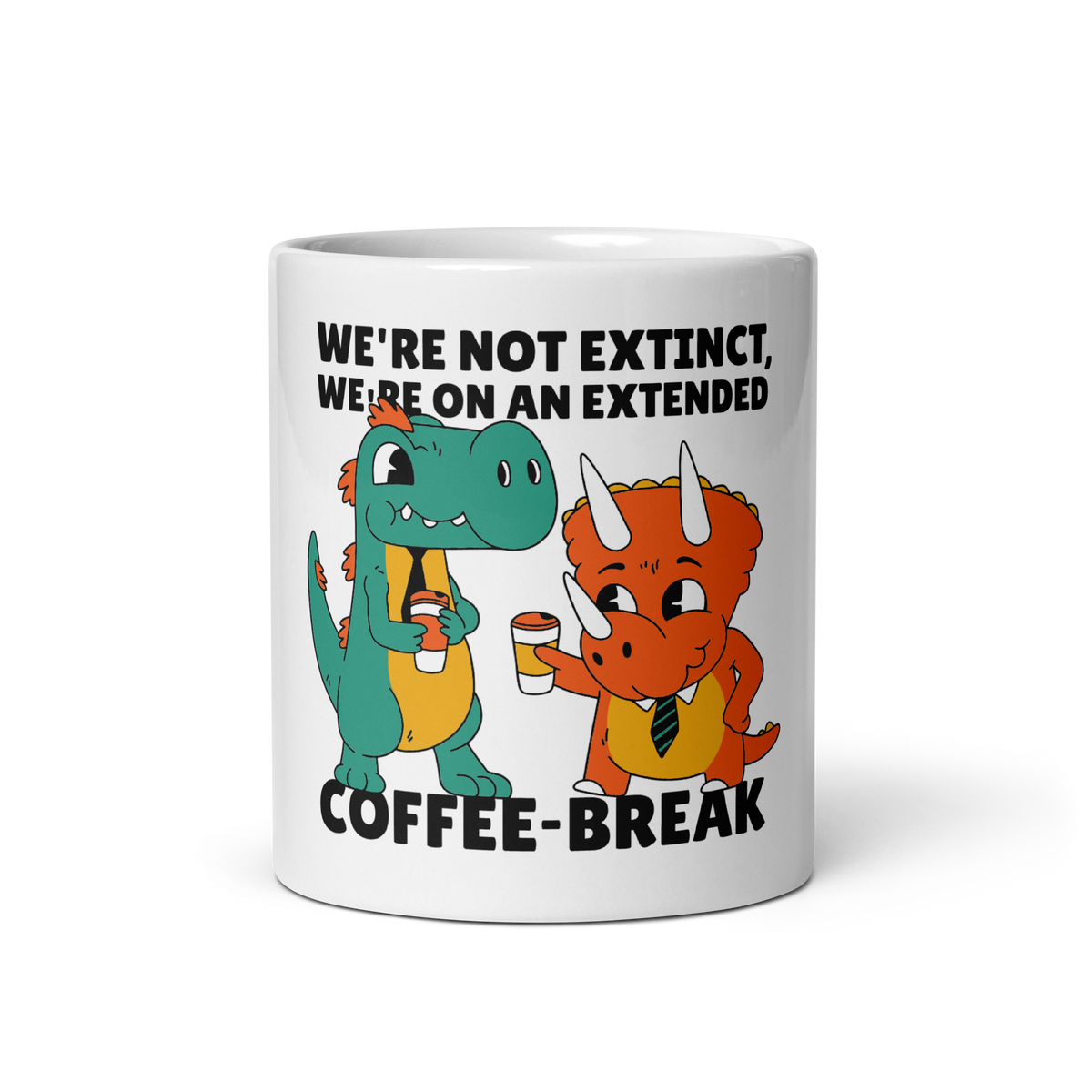 A white ceramic coffee mug featuring a cartoon graphic of two dinosaurs holding coffee cups, with the text 'WE'RE NOT EXTINCT, WE'RE ON AN EXTENDED COFFEE-BREAK'.