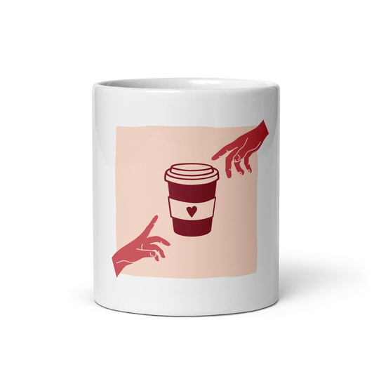 A white ceramic mug featuring a minimalist graphic print of a coffee cup between two red hands on a pale peach square background.